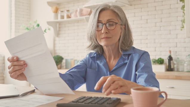 gray haired woman reading papers