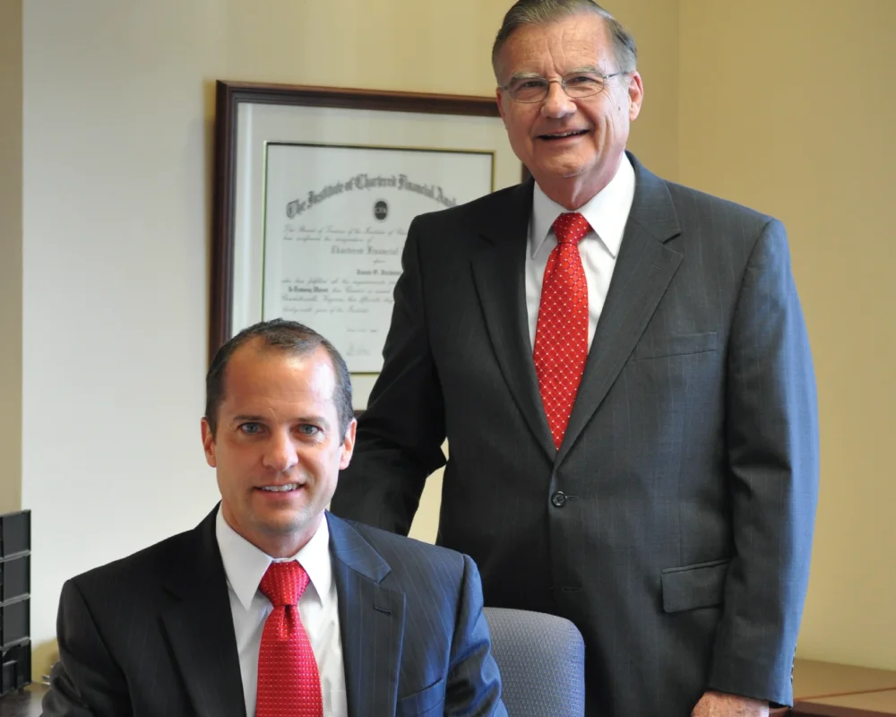 Tim Johnson stands behind his successor, Jason Jackman.