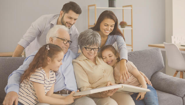 multi-generational family gathered together on the couch